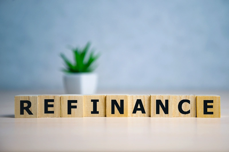 focus on wooden blocks with letters Refinance text. Concept image.